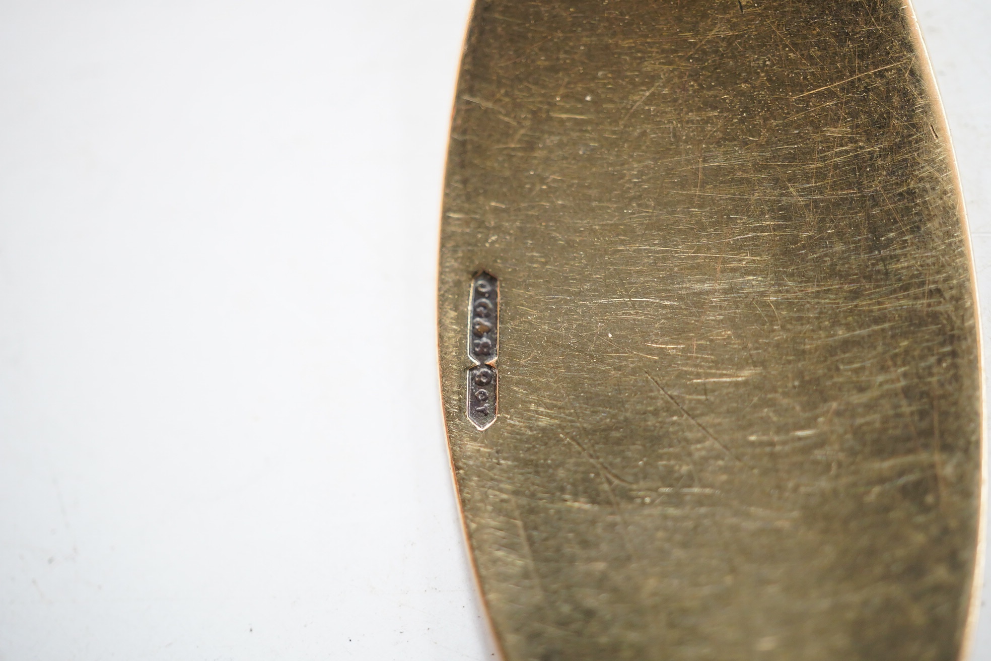 A 9ct curb link identity bracelet, with engraved inscription, 19cm, 12.5 grams, together with a yellow metal Egyptianesque ring and a yellow metal and three stone garnet set ring. Condition - fair